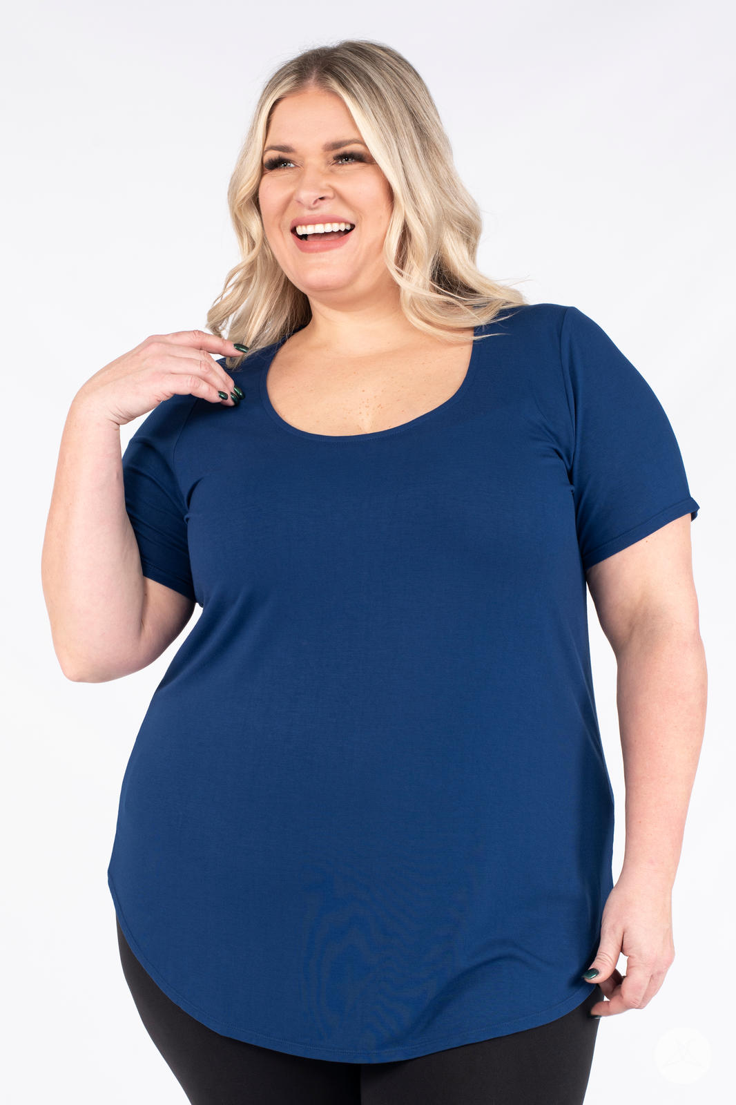 Plus size woman smiling wearing blue Classic Tee by SweetLegs Canada with scoop neck and curved hem front view