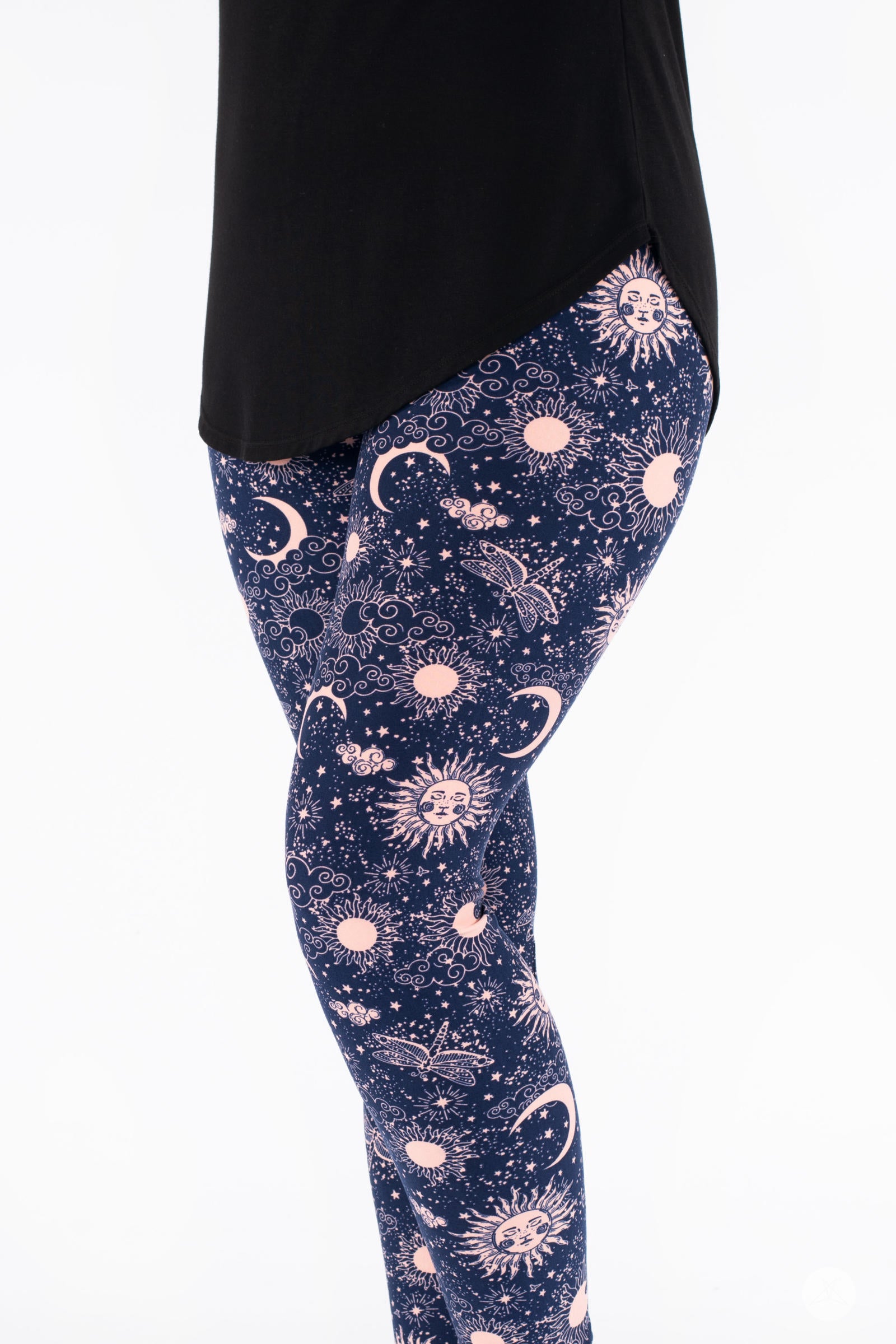 SweetLegs Celestial Skies leggings with blush pink suns, moons, dragonflies, and stars on deep navy background