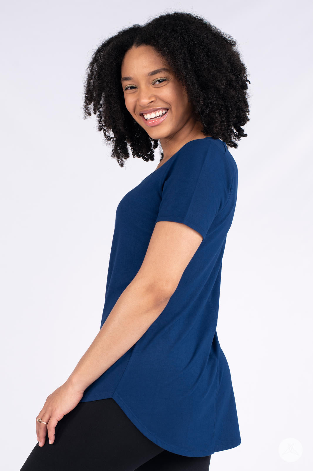 Woman smiling wearing navy Classic Tee by SweetLegs Canada with short sleeves and high to low hem side view