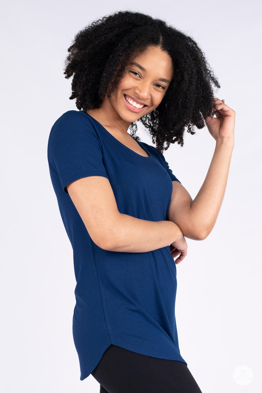 Smiling woman wearing navy Classic Tee by SweetLegs Canada with scoop neck and high to low hem side profile