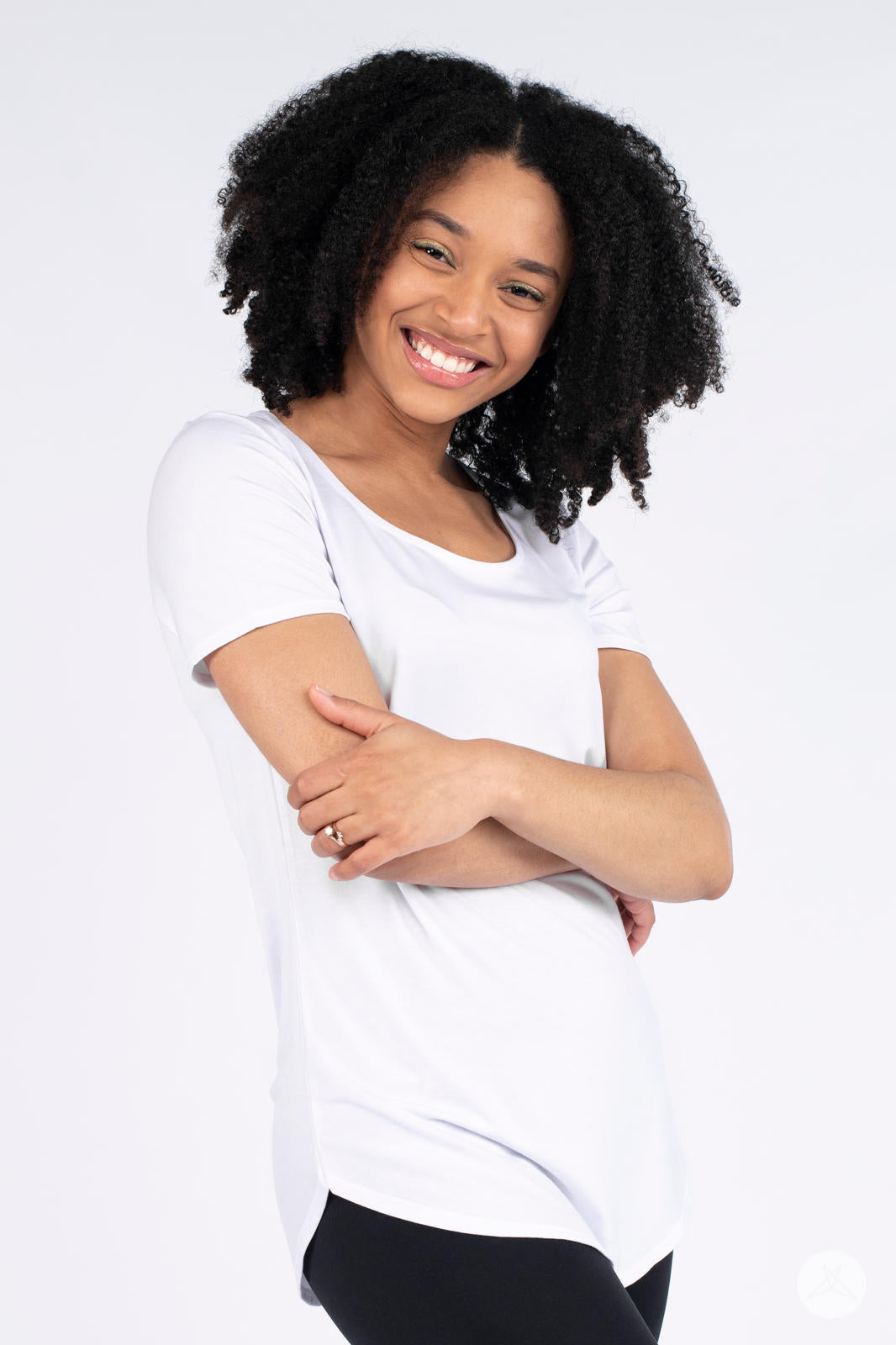 Front view of Classic Tee by SweetLegs Canada worn by smiling model with arms crossed on a white background
