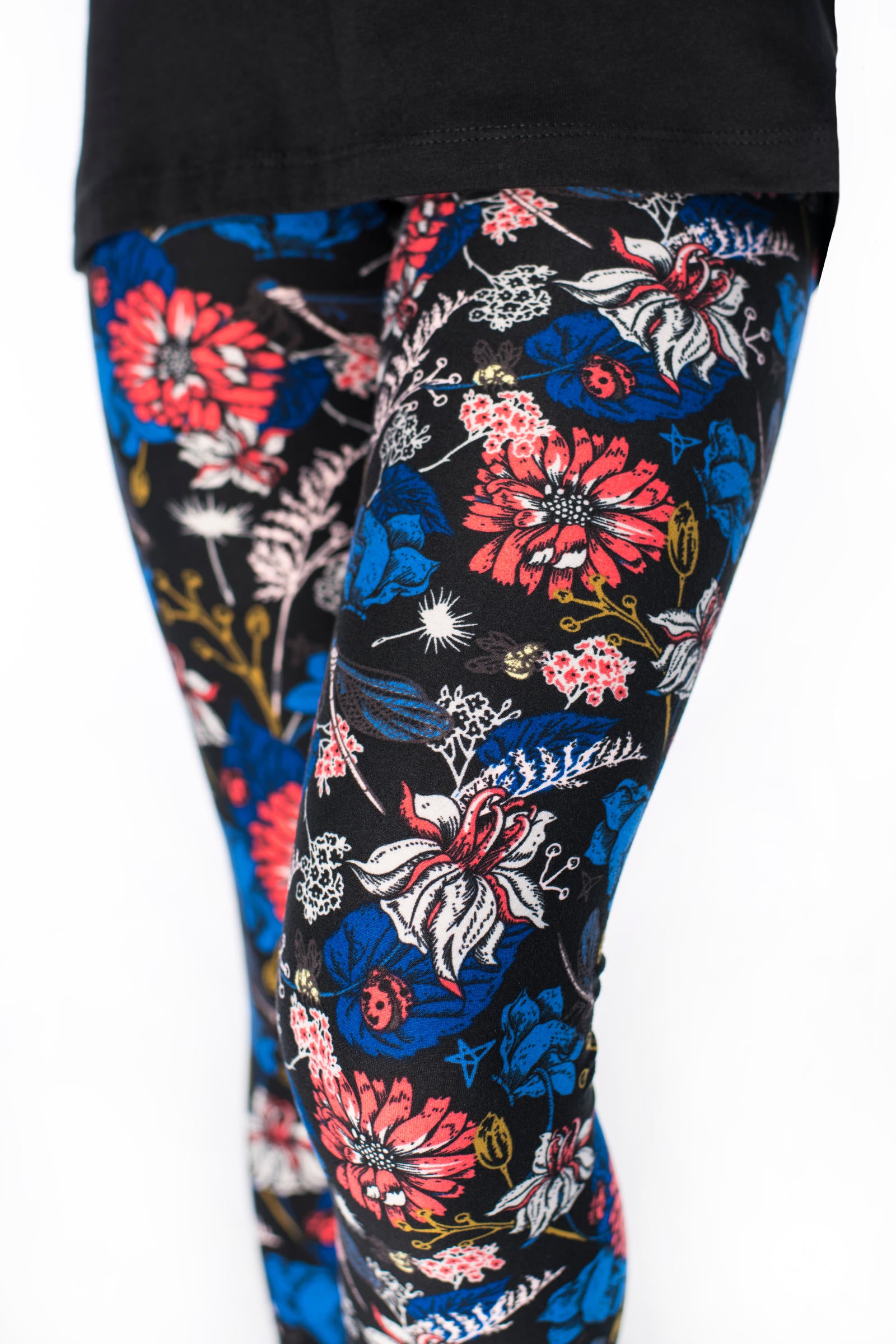 Close-up of SweetLegs Lovely Day Kids leggings with coral and persian blue floral garden design on black background