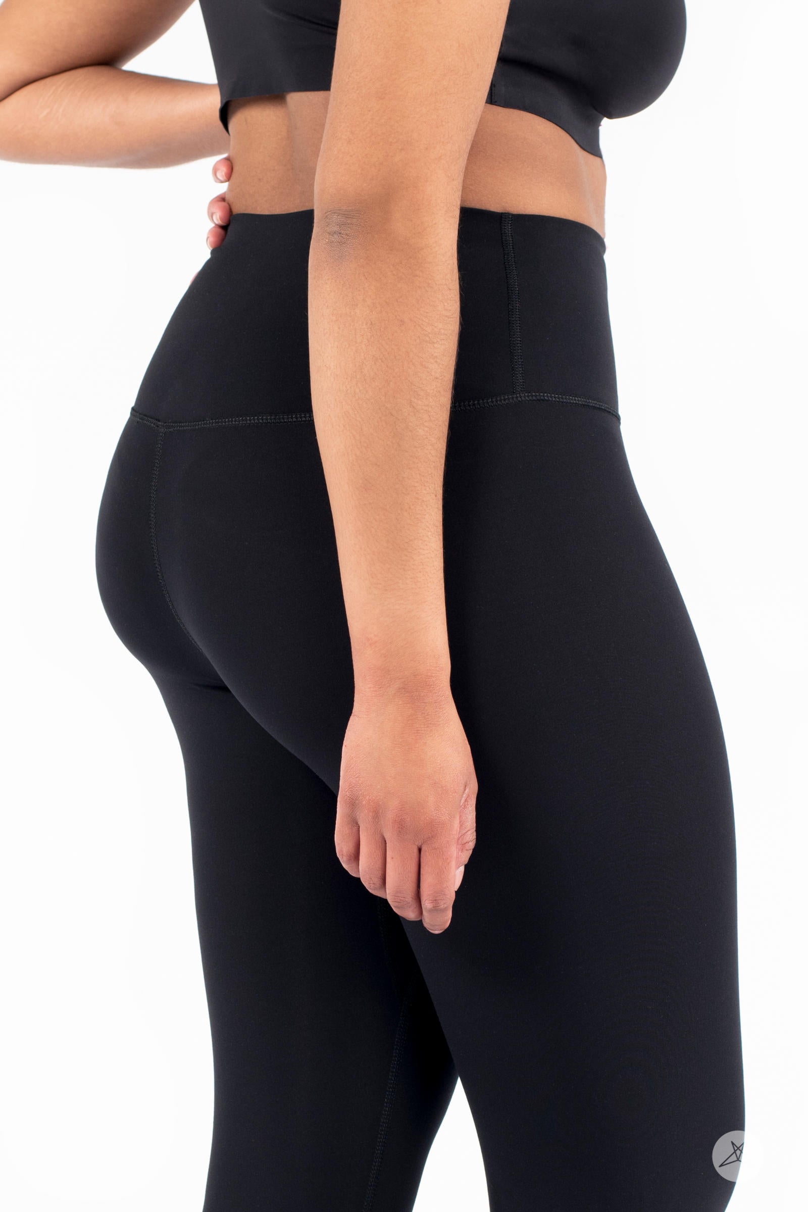 Side view of model wearing black Free Motion Crops by Athleisure SweetLegs collection on white background