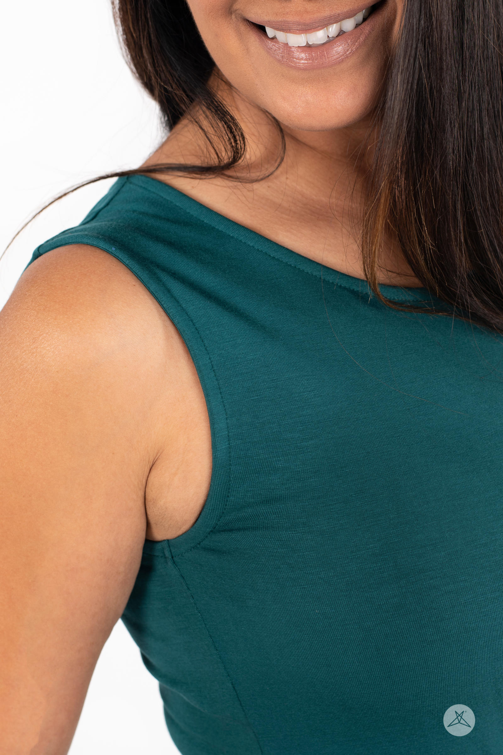Close-up of smiling model wearing SweetTops The Weekender Dress in dark green sleeveless fabric detail