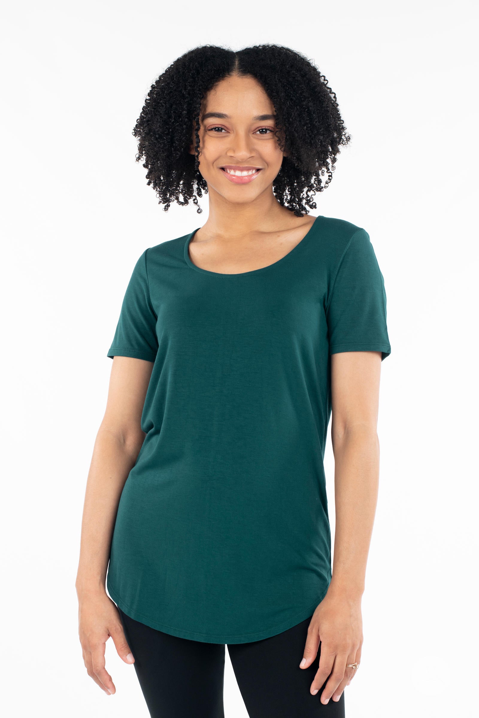 Smiling woman wearing dark green Classic Tee by SweetLegs Canada with scoop neck and relaxed fit front view