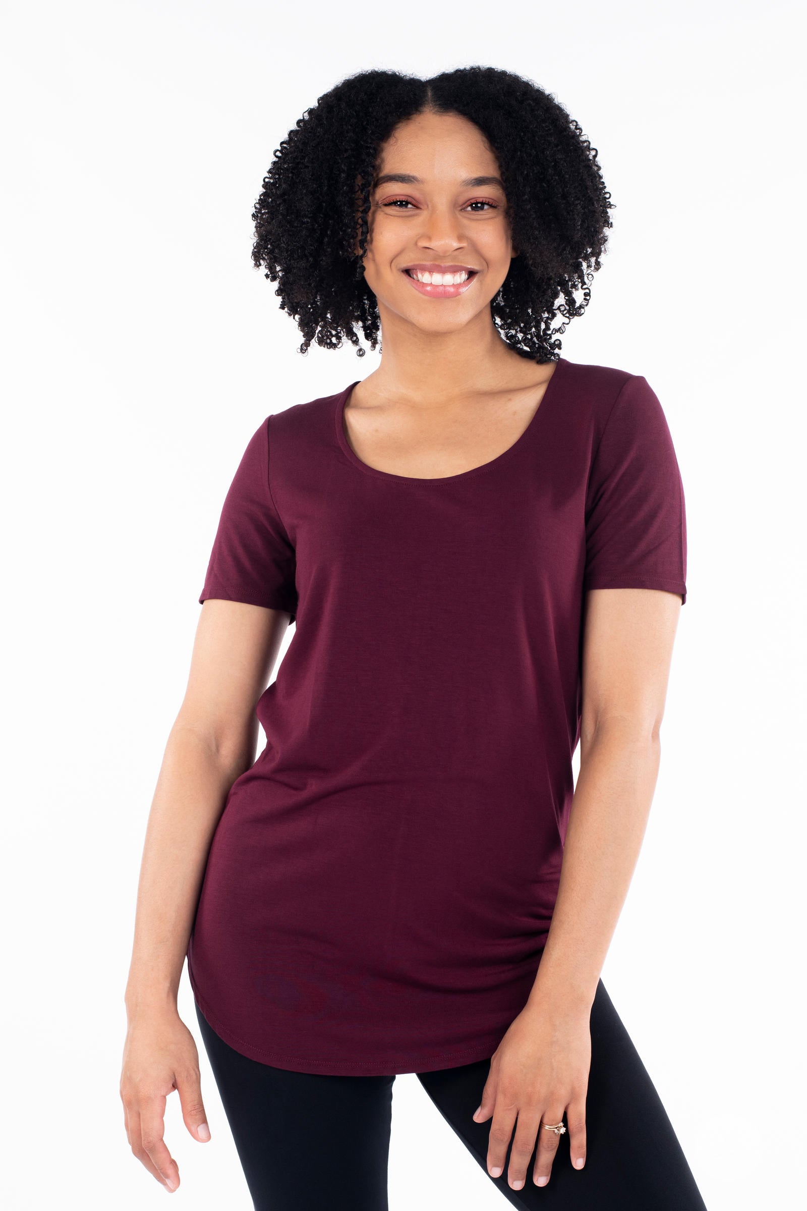 Smiling woman wearing a maroon Classic Tee by SweetLegs Canada with scoop neck and short sleeves front view