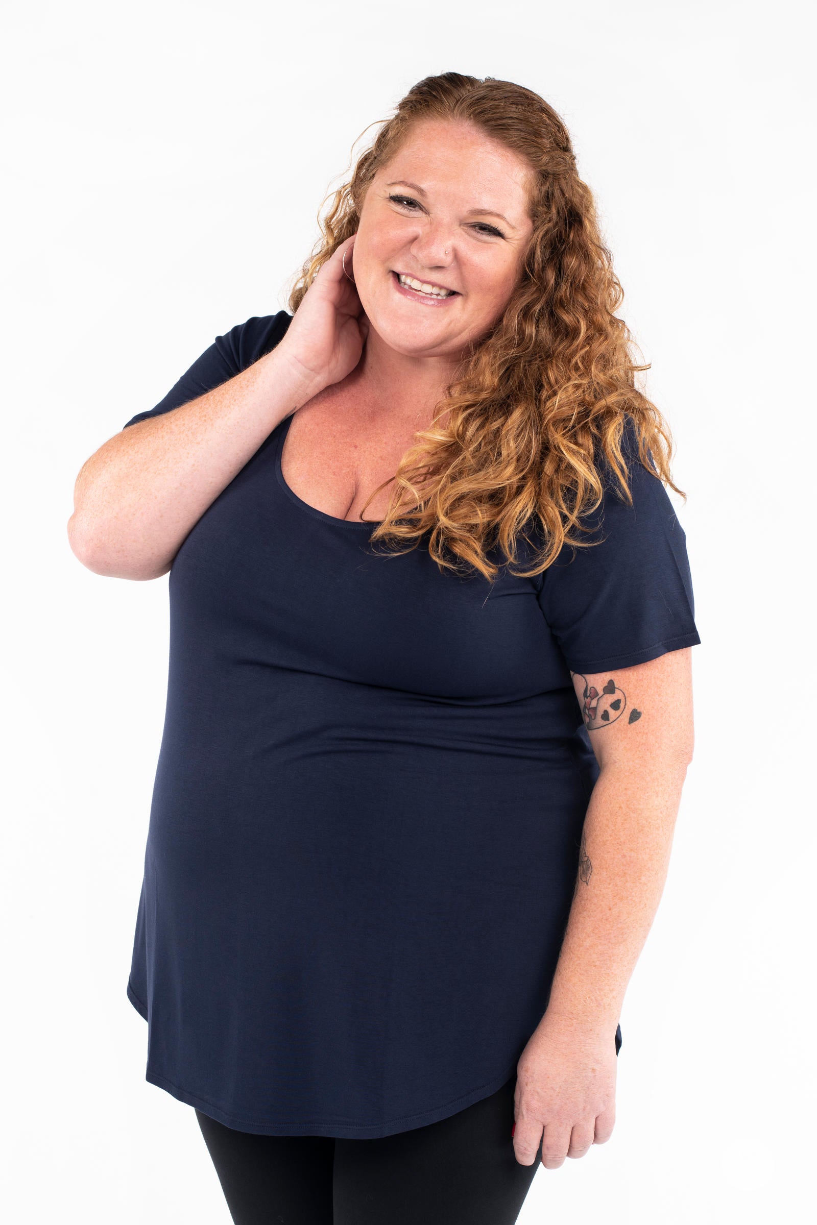 Plus size woman smiling wearing navy Classic Tee by SweetLegs Canada with scoop neck and relaxed fit front view