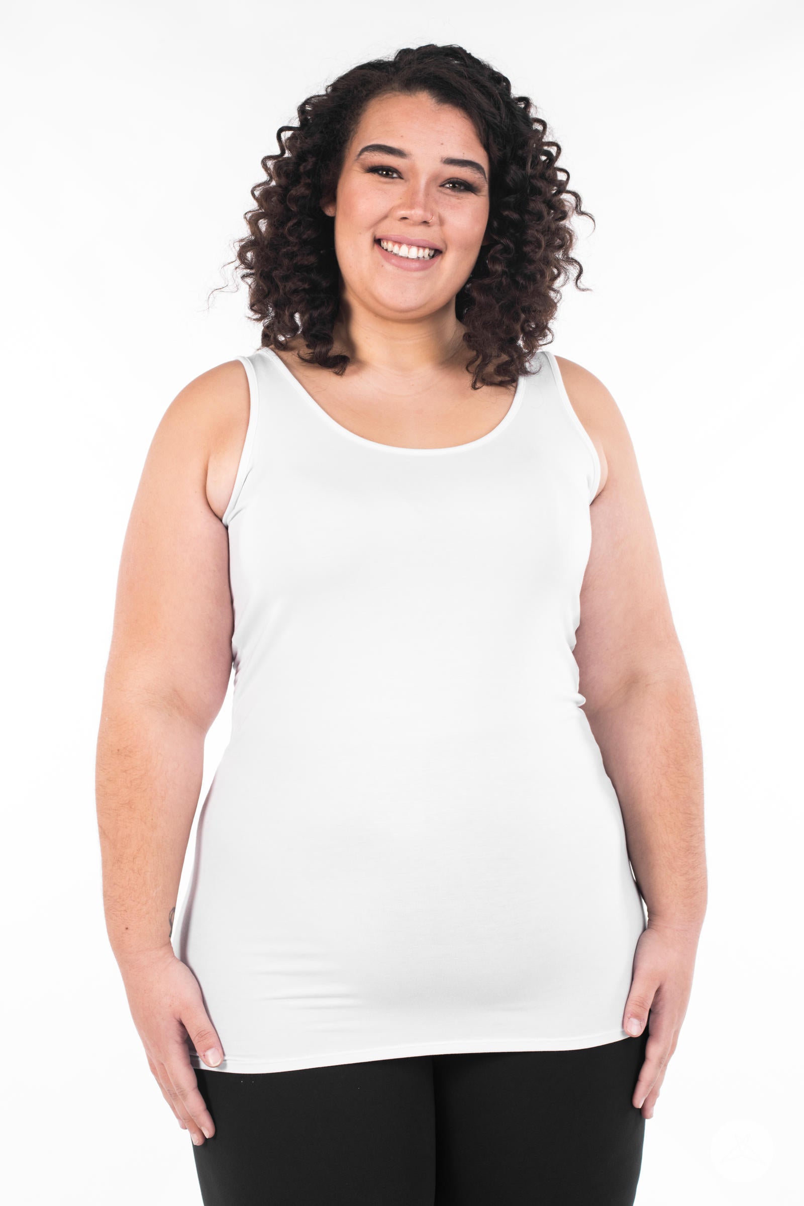 Smiling woman modeling SweetLegs Canada Classic Layering Tank in white with a smooth, fitted style on white background