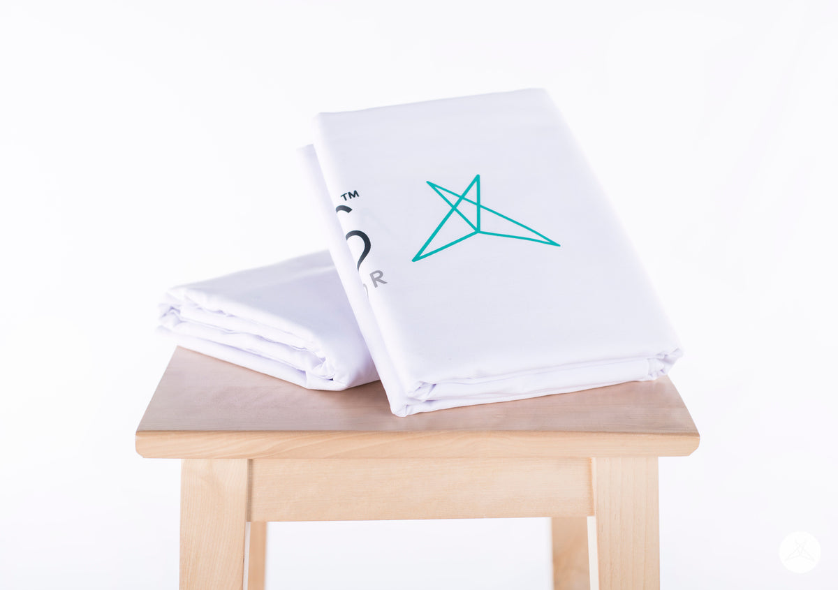WHITE 6' Table Throw by SweetLegs Canada folded on wooden table with partial logo visible on white fabric
