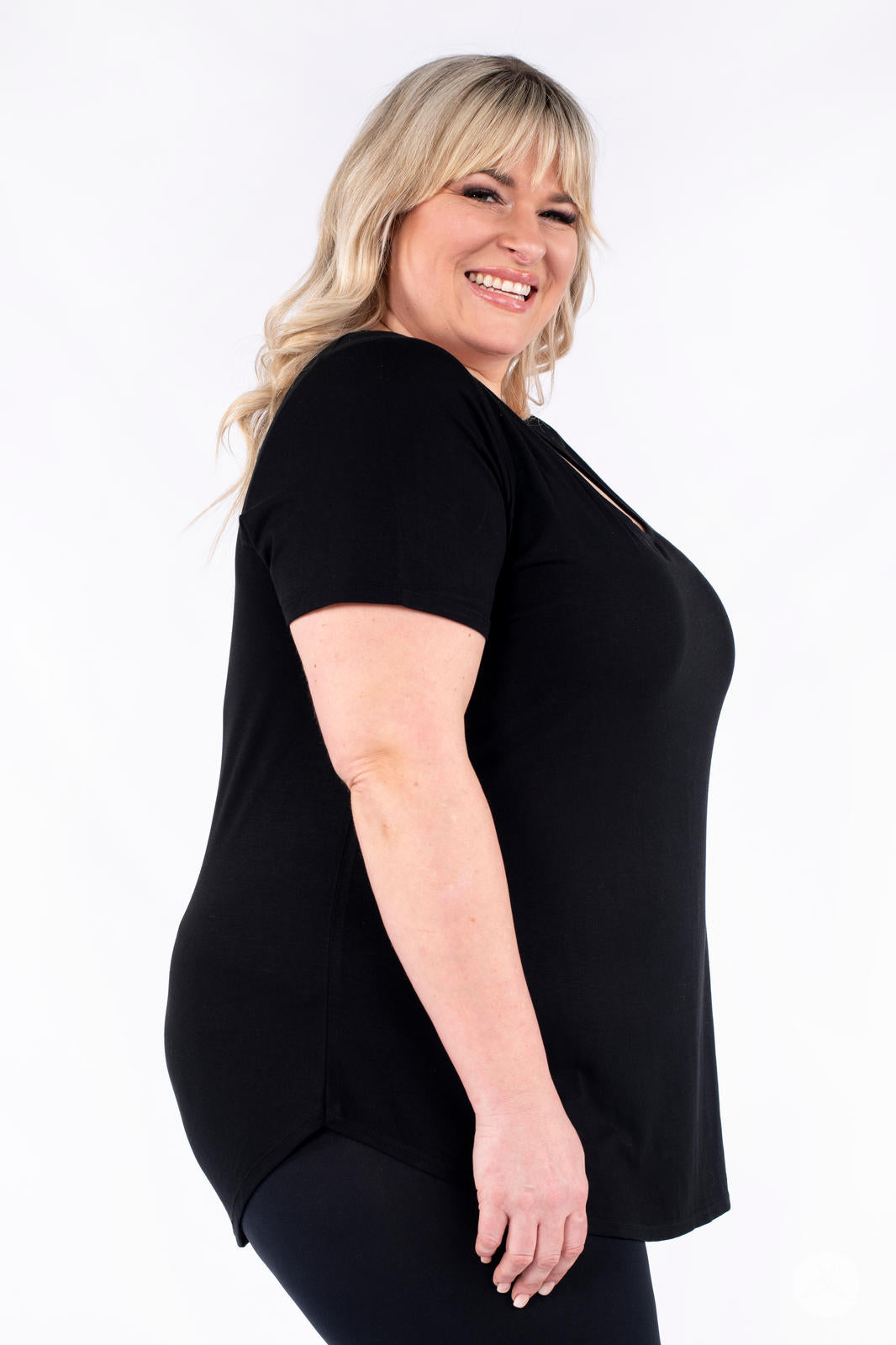 Plus size woman laughing wearing black Classic Tee by SweetLegs Canada with short sleeves and side view