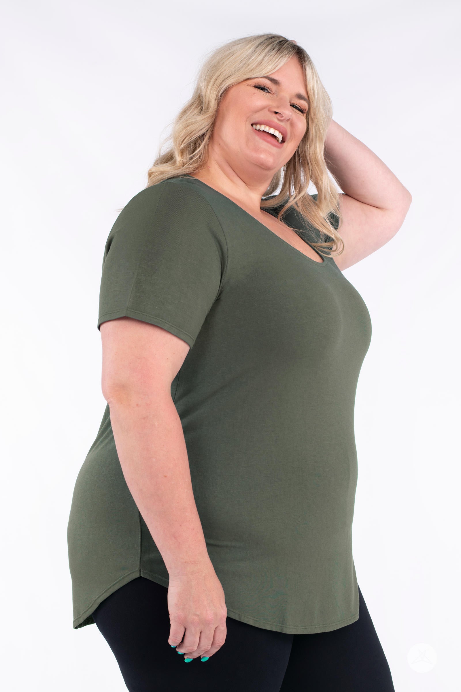 Plus size model smiling wearing olive Classic Tee by SweetLegs Canada with short sleeves and high to low hem in side angle