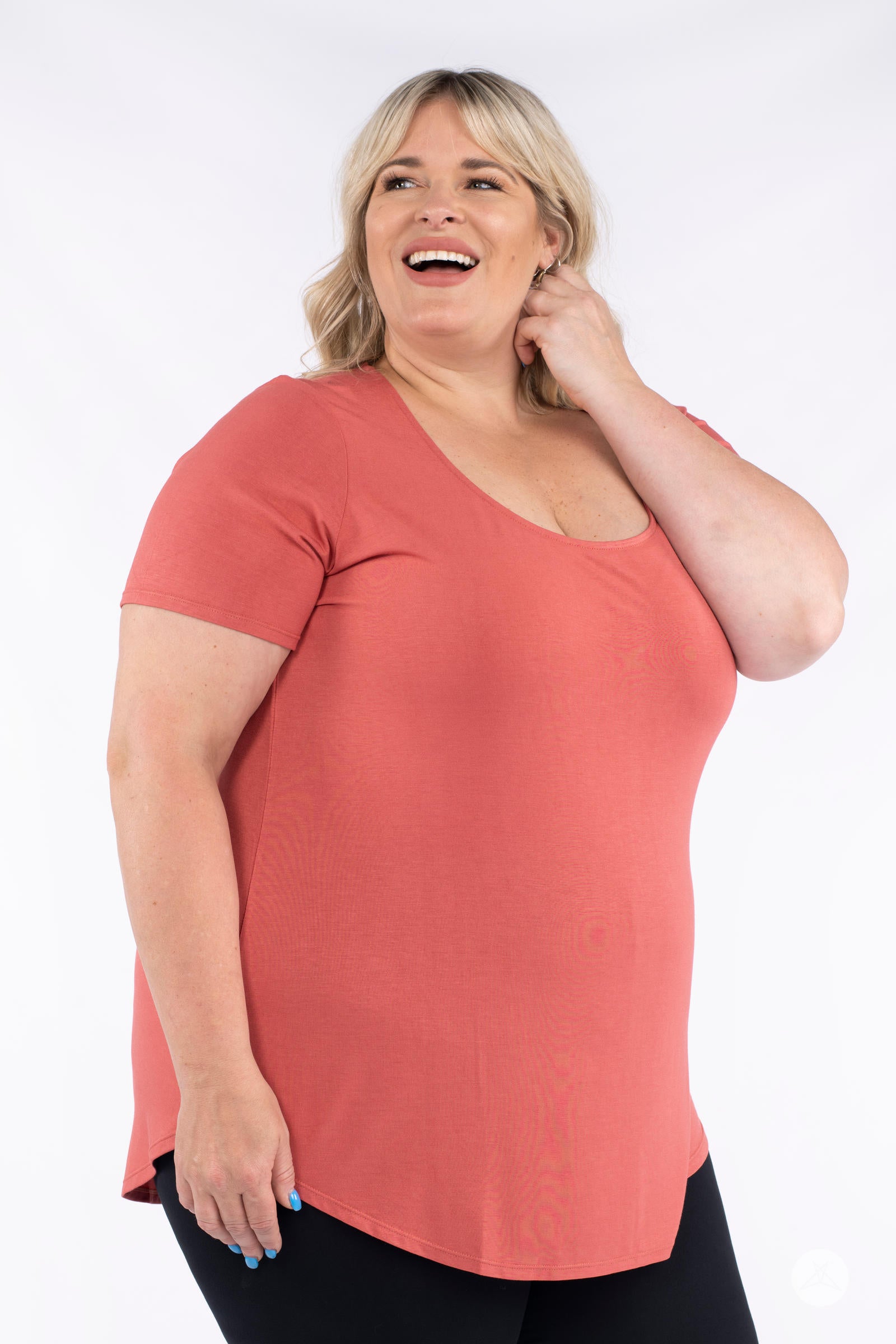 Smiling plus size woman wearing rust Classic Tee by SweetLegs Canada with scoop neck and relaxed fit side view