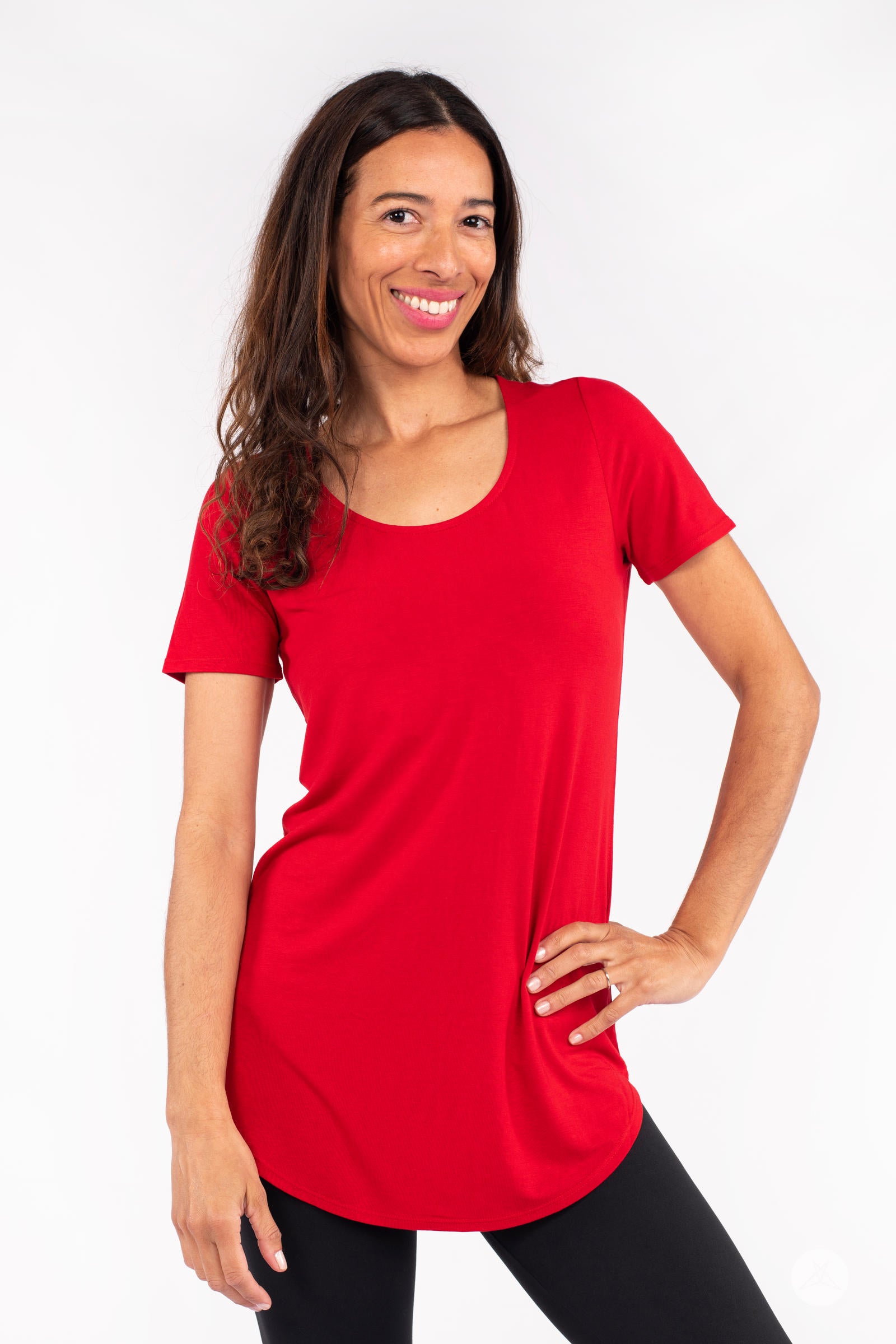 Woman smiling wearing red Classic Tee by SweetLegs Canada with scoop neck and short sleeves posing with hand on hip