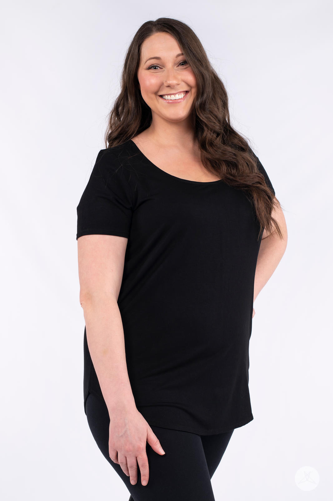 Smiling woman wearing black Classic Tee by SweetLegs Canada with scoop neck and relaxed fit front view