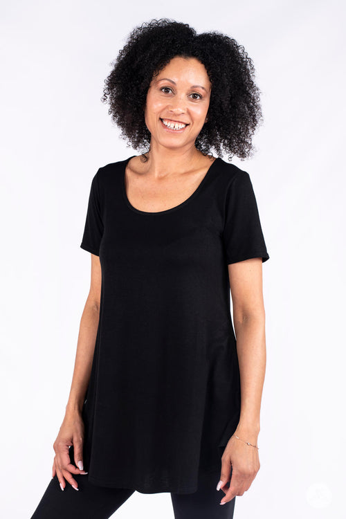 Smiling woman wearing SweetLegs Canada Classic Tunic in black with scoop neck and short sleeves on white background