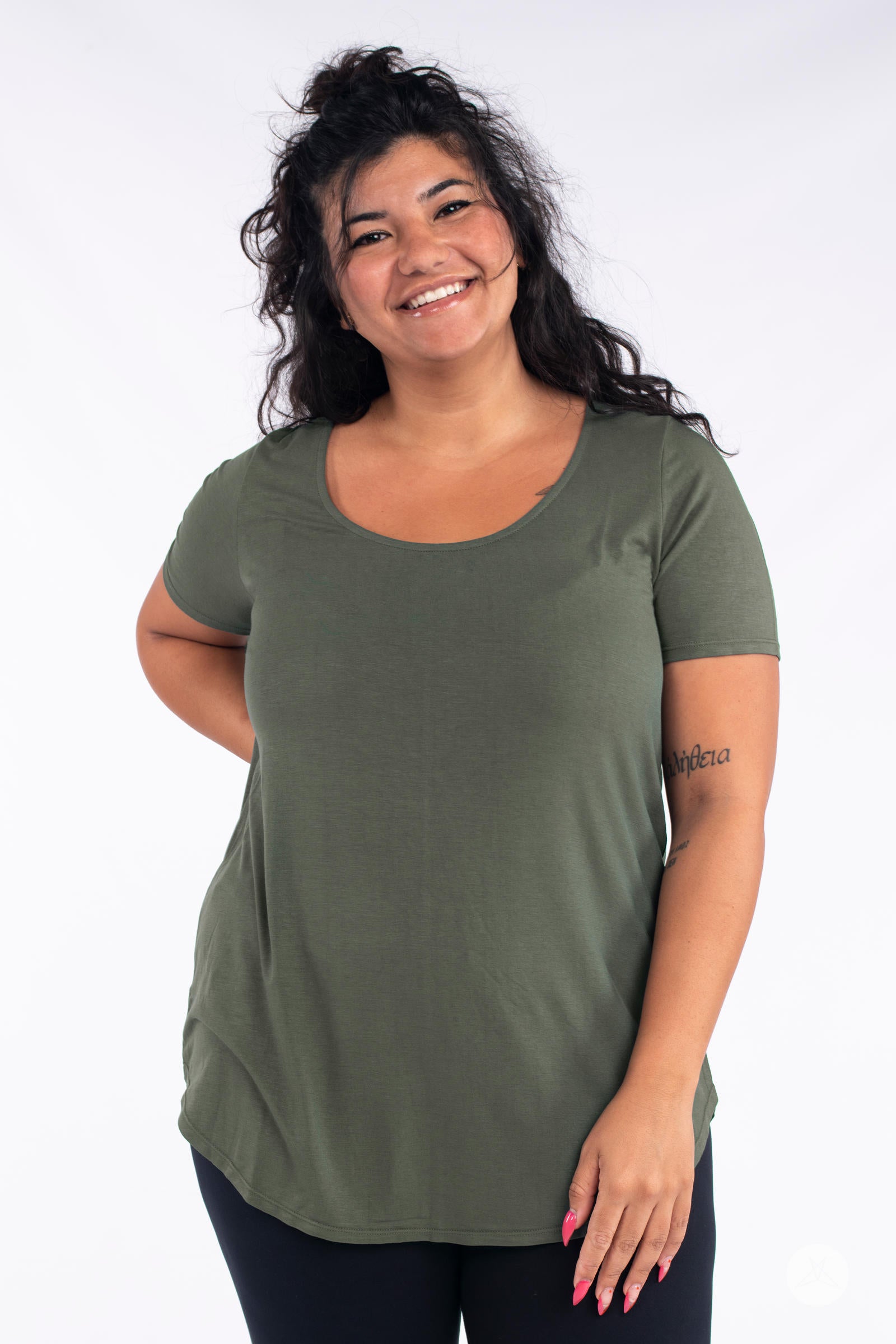 Smiling model wearing olive Classic Tee by SweetLegs Canada with scoop neckline and short sleeves on white background