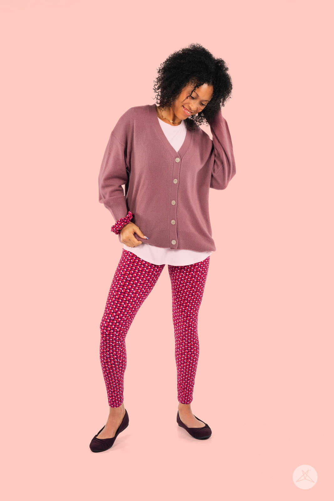 Full-length view of SweetLegs Lovesick leggings with vibrant duo-tone pink and purple heart pattern worn with mauve cardigan