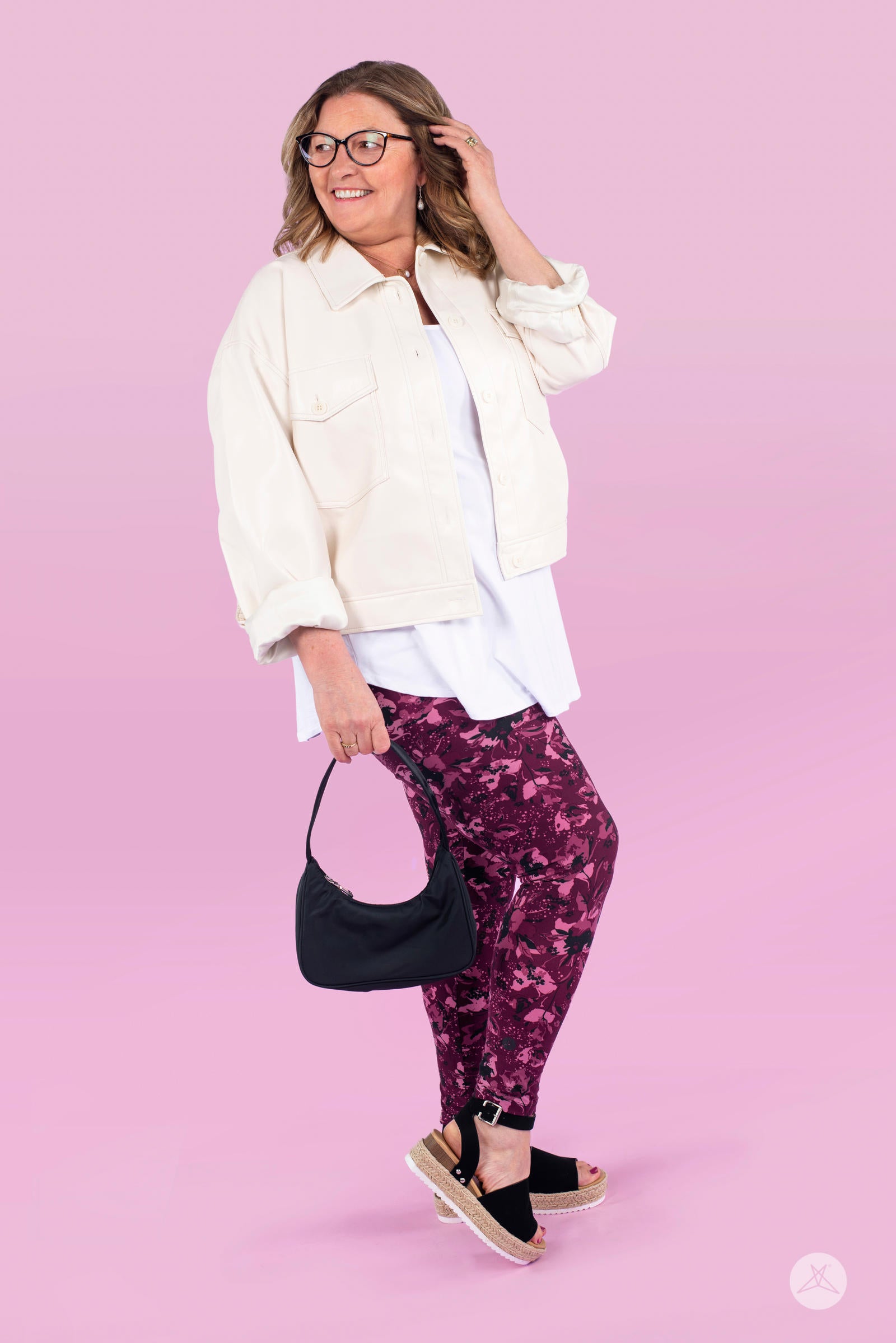 Plus size model wearing SweetLegs Merlot Dreams leggings with hand-drawn floral design in shades of mulberry on maroon background