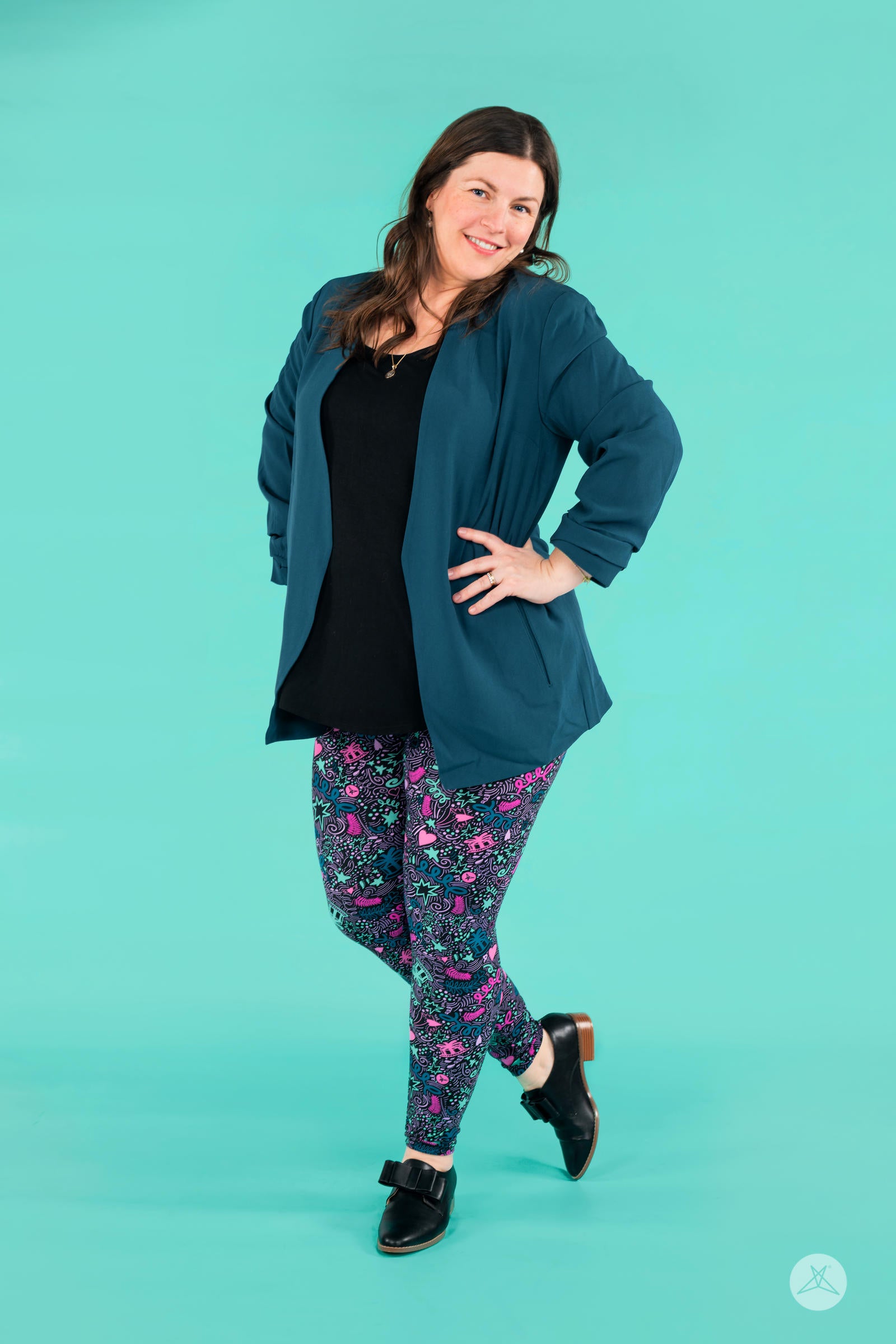 Full-length view of woman wearing SweetLegs Partylicious leggings with colorful star and heart print on turquoise background