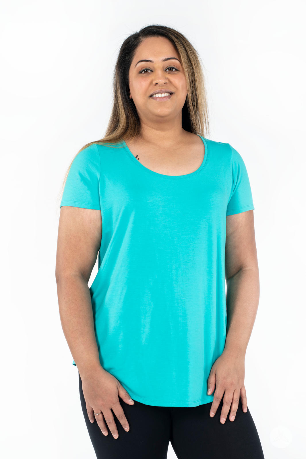 Woman smiling wearing SweetLegs Canada Scoop Neck Tee in bright turquoise with short sleeves front view
