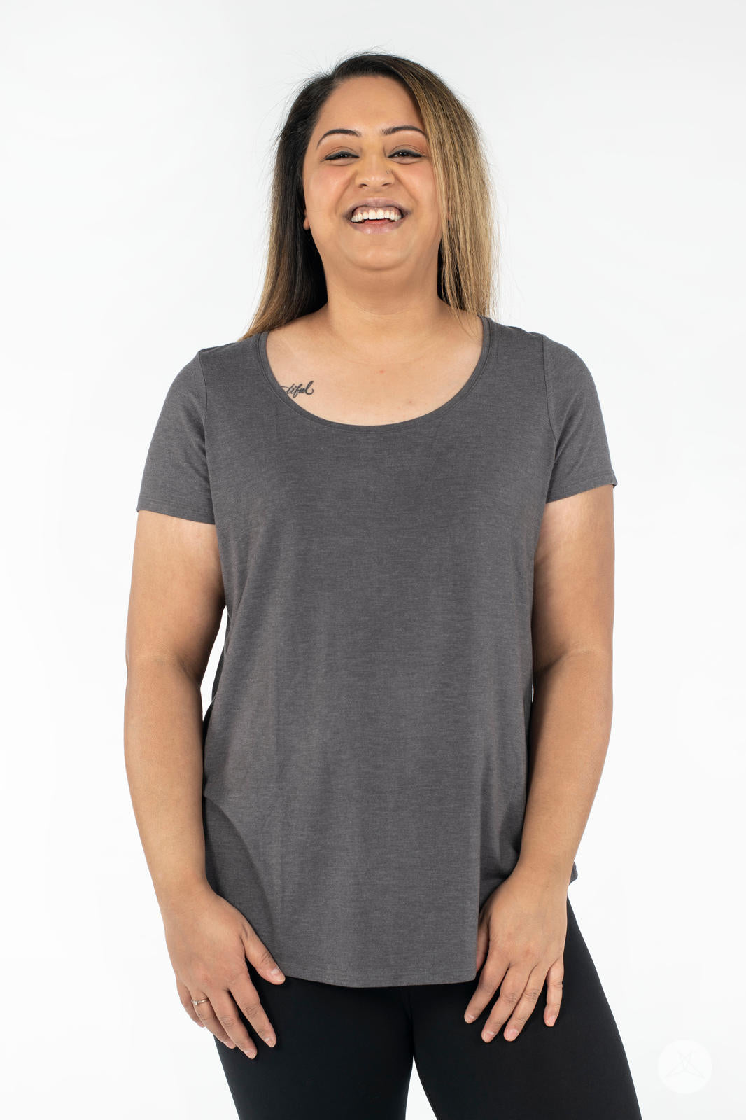 Smiling woman wearing SweetLegs Canada Scoop Neck Tee in charcoal grey with scoop neckline front view standing
