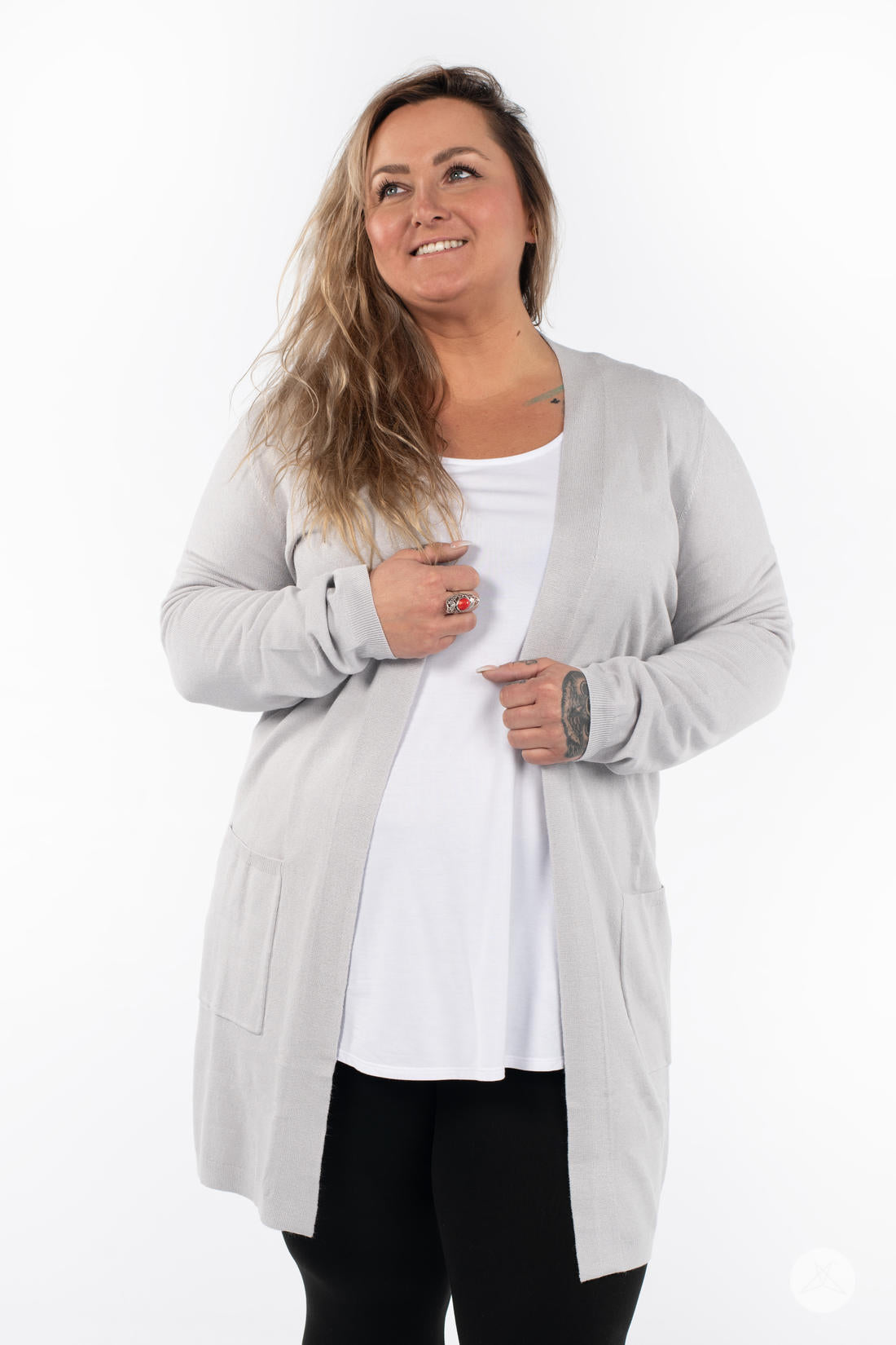 Woman wearing SweetLegs Canada Spring Cardigan in light grey with patch pockets over white top and black leggings