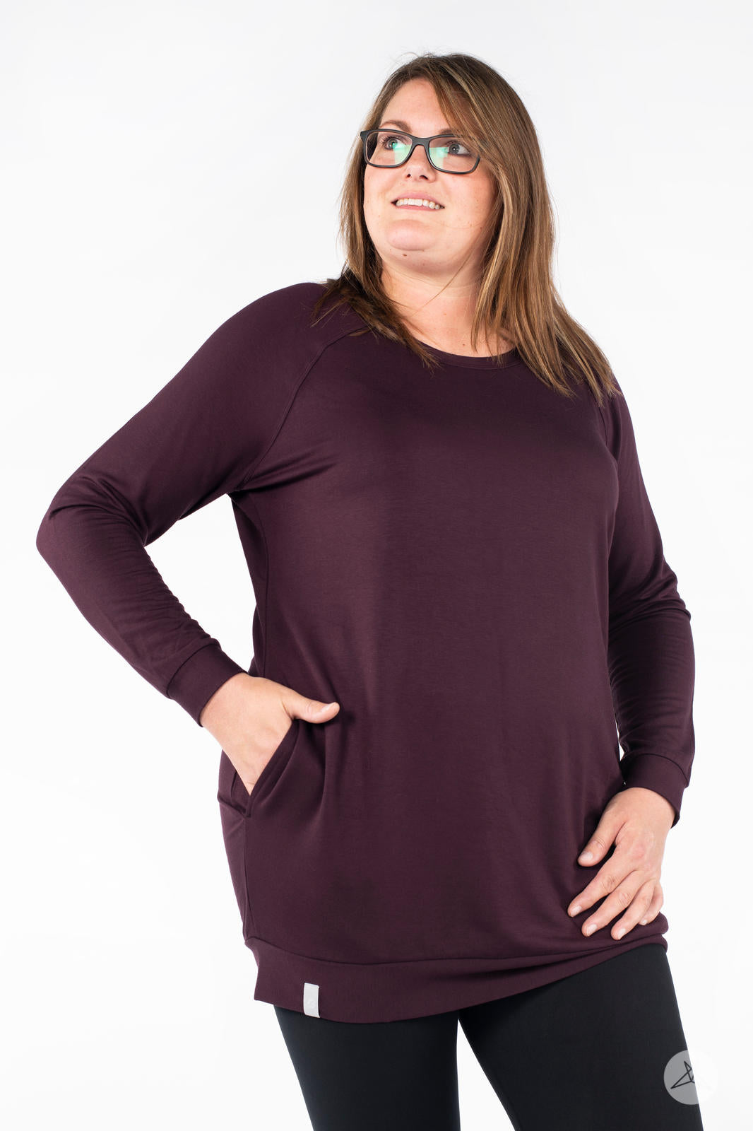 Plus-size model wearing SweetLegs Canada Everyday Raglan Pullover in dark plum standing with hands in pockets