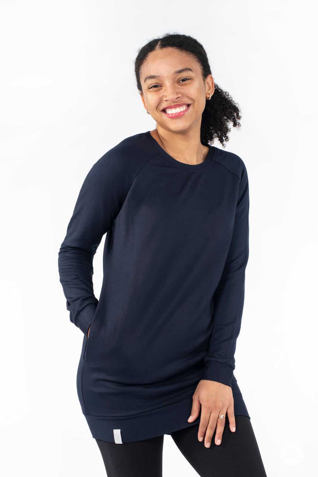 Smiling model wearing SweetLegs Canada Everyday Raglan Pullover in navy with hands in pockets and relaxed pose