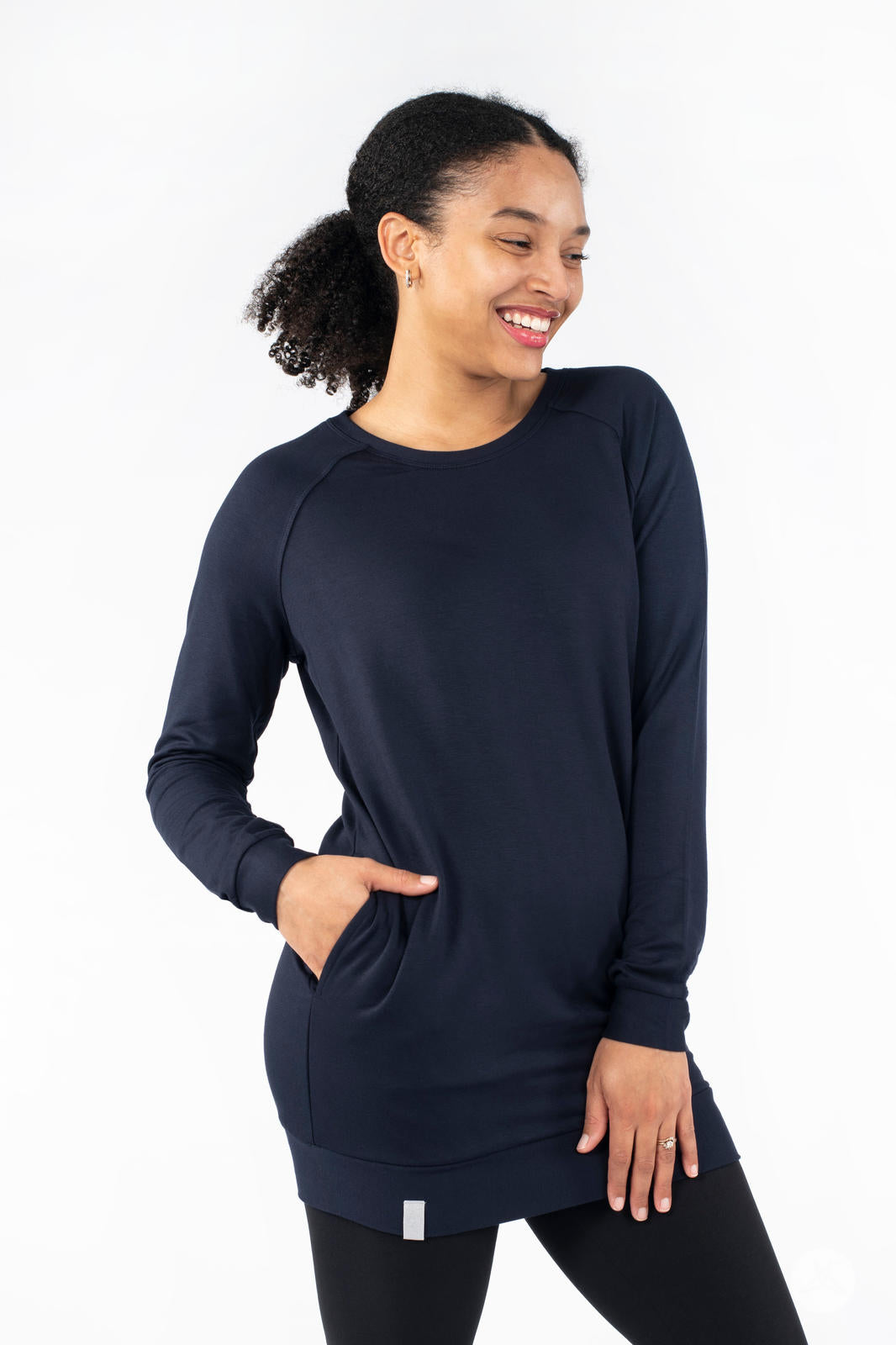 Smiling model wearing SweetLegs Canada Everyday Raglan Pullover in navy with hands resting casually in pockets