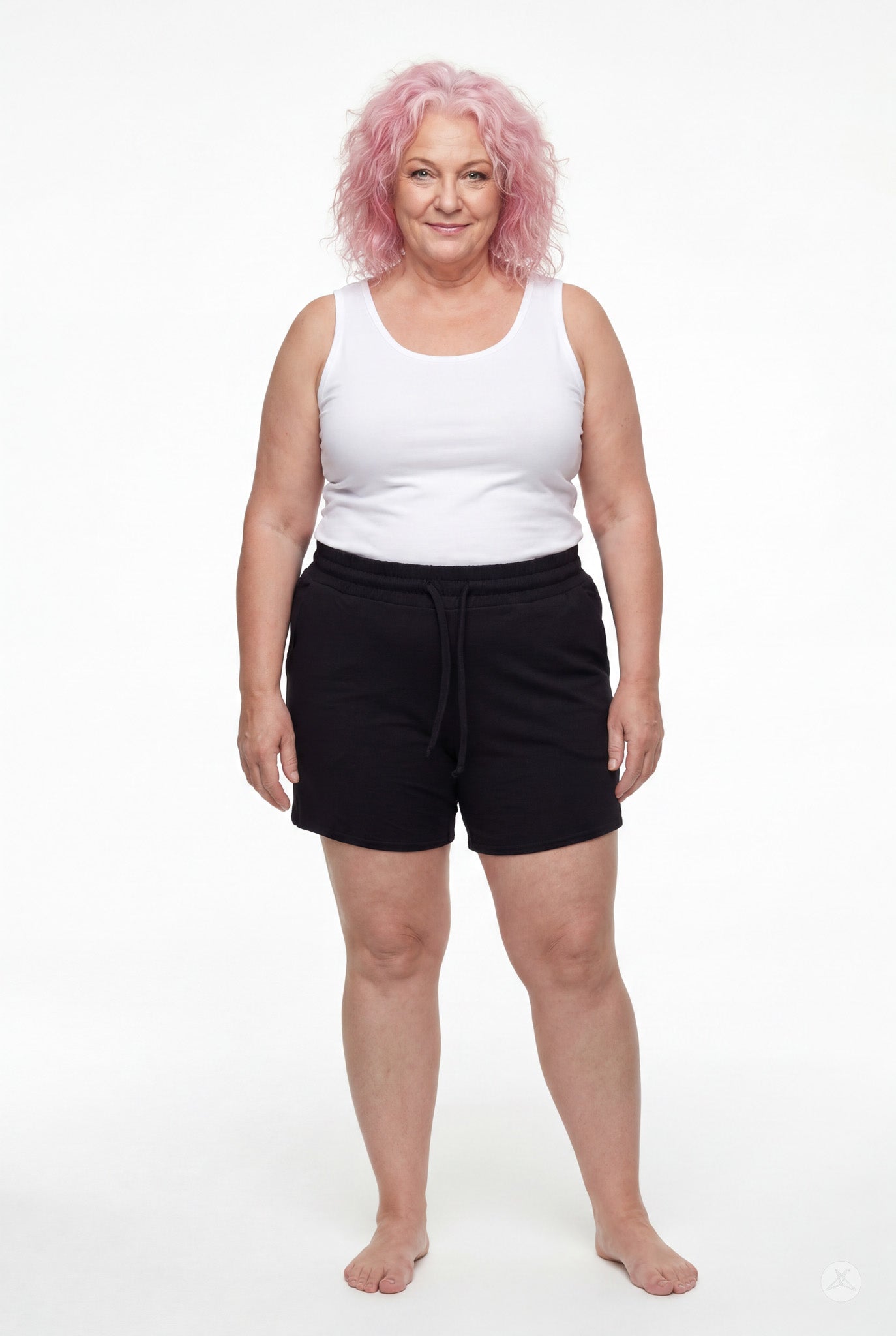 Woman wearing black Lounge Shorts by SweetLegs with drawstring waist and relaxed fit standing barefoot on white background