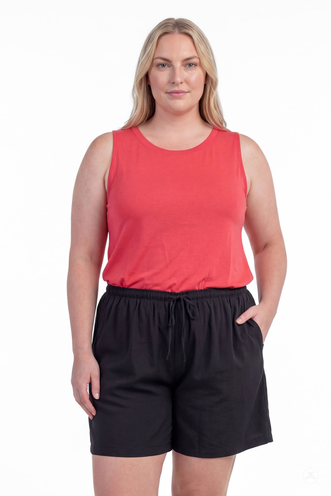 Woman wearing black Breeze Shorts by SweetLegs with elastic waistband and drawstring, paired with sleeveless coral top.