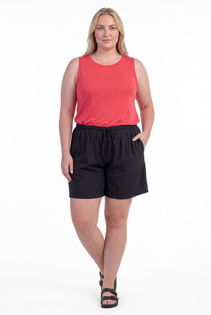 Woman wearing black Breeze Shorts by SweetLegs with elastic waistband and pockets, paired with sleeveless coral top