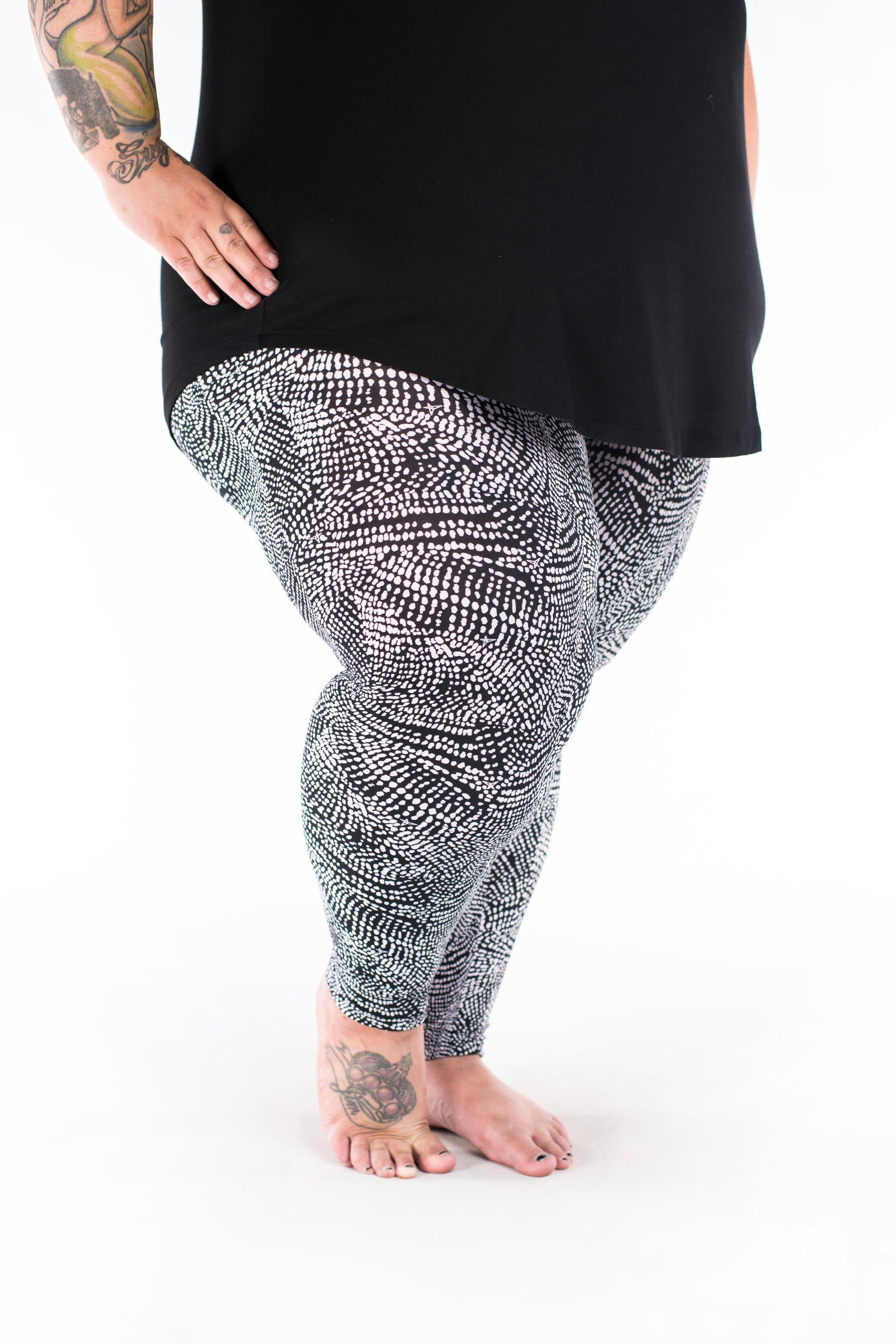 Plus size legs wearing SweetLegs Charmed leggings with detailed black and white abstract snakeskin pattern