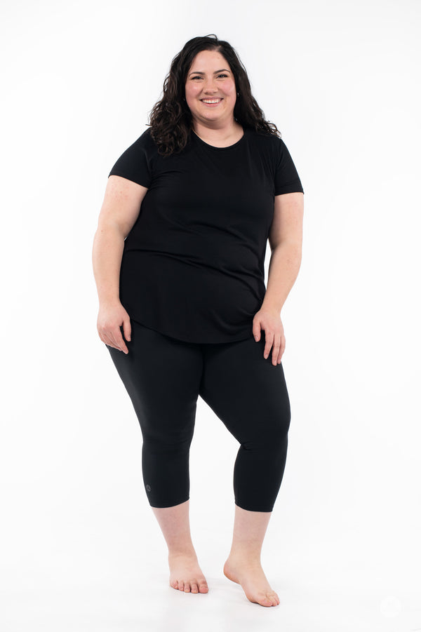 SweetLegs Black Crops worn by smiling plus-size model standing barefoot against white background