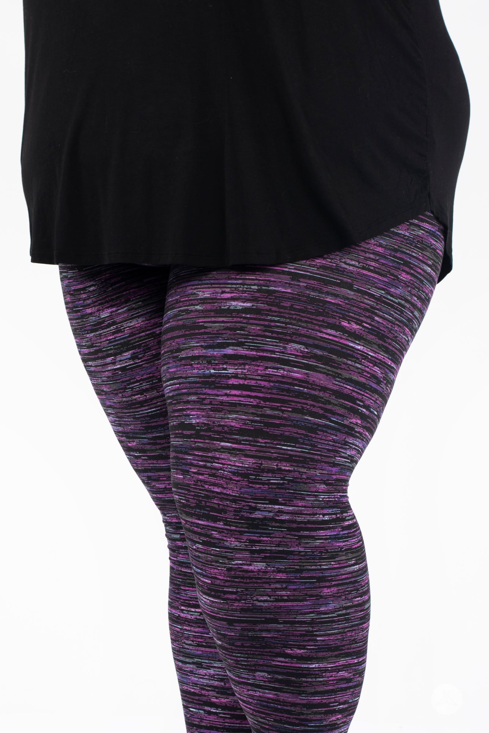 Close-up of SweetLegs Twilight Opal leggings showcasing black, purple, pink, and turquoise streaks in dynamic pattern