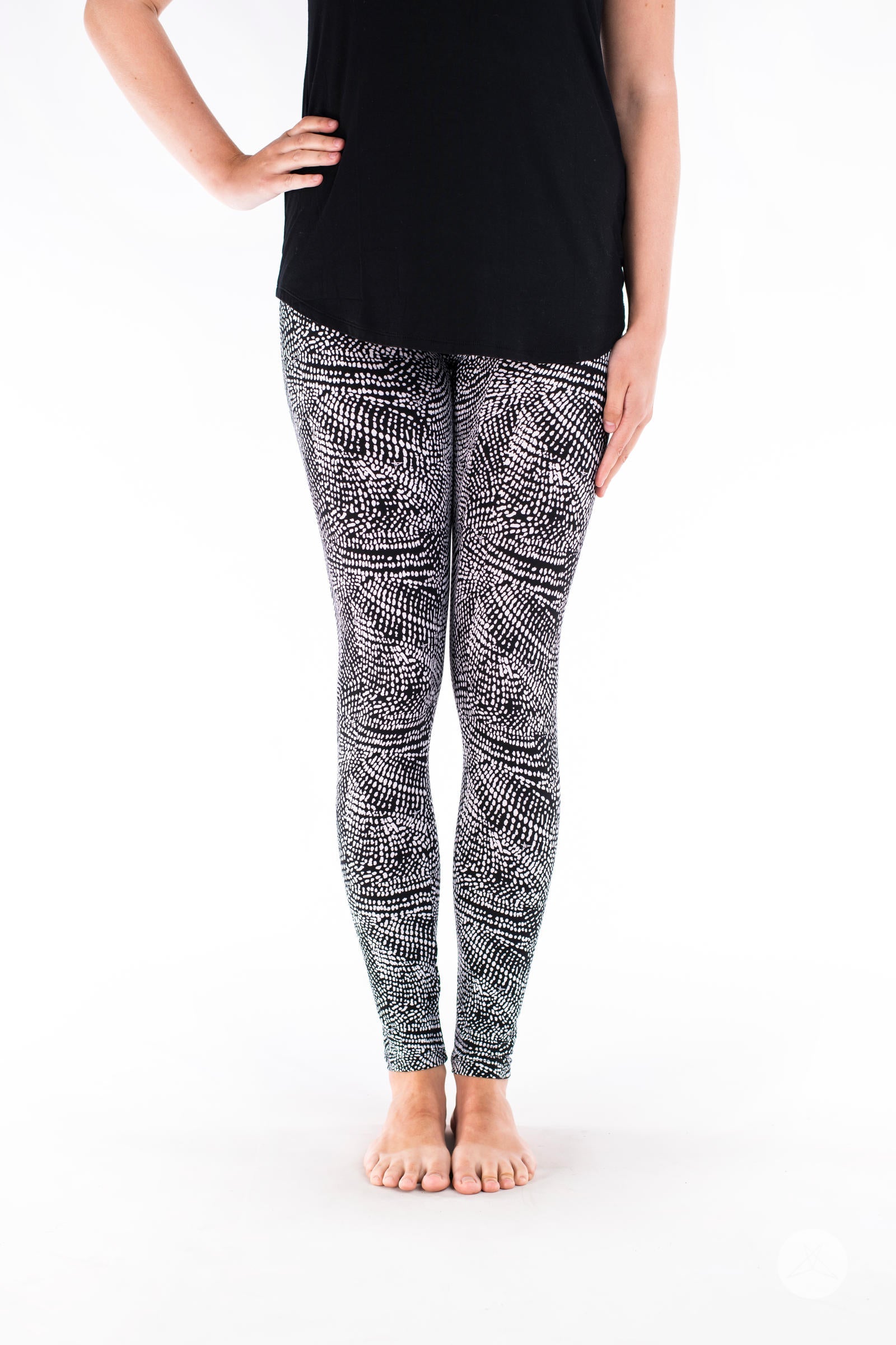 Front view of SweetLegs Charmed leggings with a black and white deconstructed snakeskin pattern on model legs