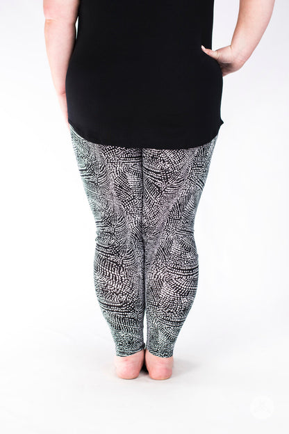 Rear view of SweetLegs Charmed leggings with intricate black and white textured snakeskin design on legs