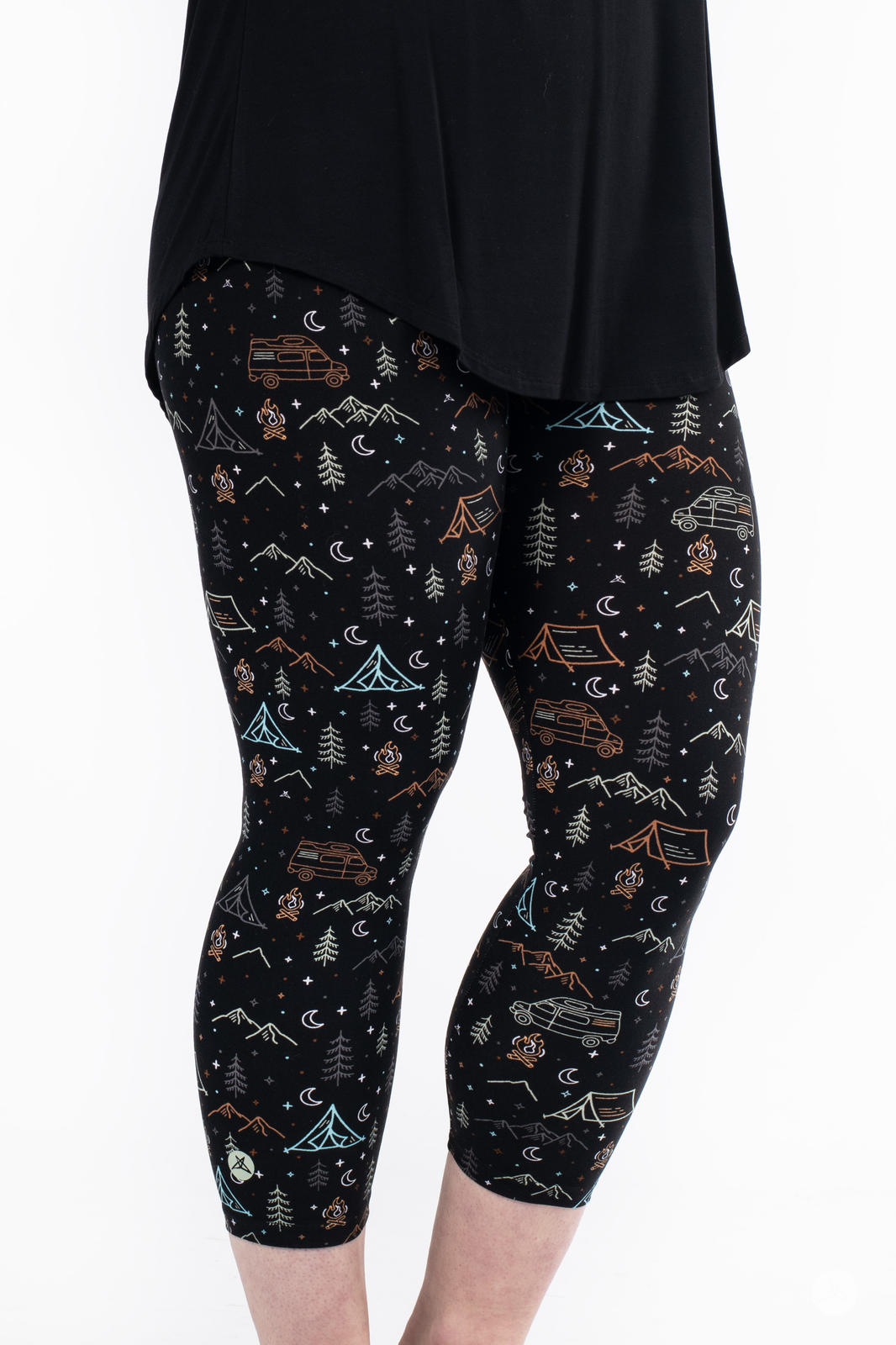 Plus size model wearing Vault - Signature Crops by SweetLegs with camping and mountain pattern on black background