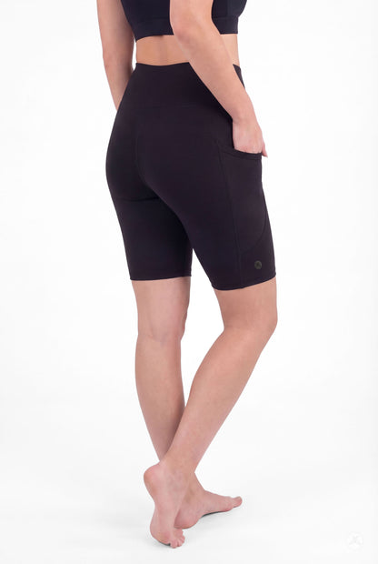 Back view of model wearing SweetLegs Black High-Waisted Pocket Biker Shorts with hand in side pocket