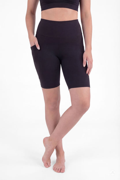 Model wearing SweetLegs Black High-Waisted Pocket Biker Shorts with hand in side pocket front view