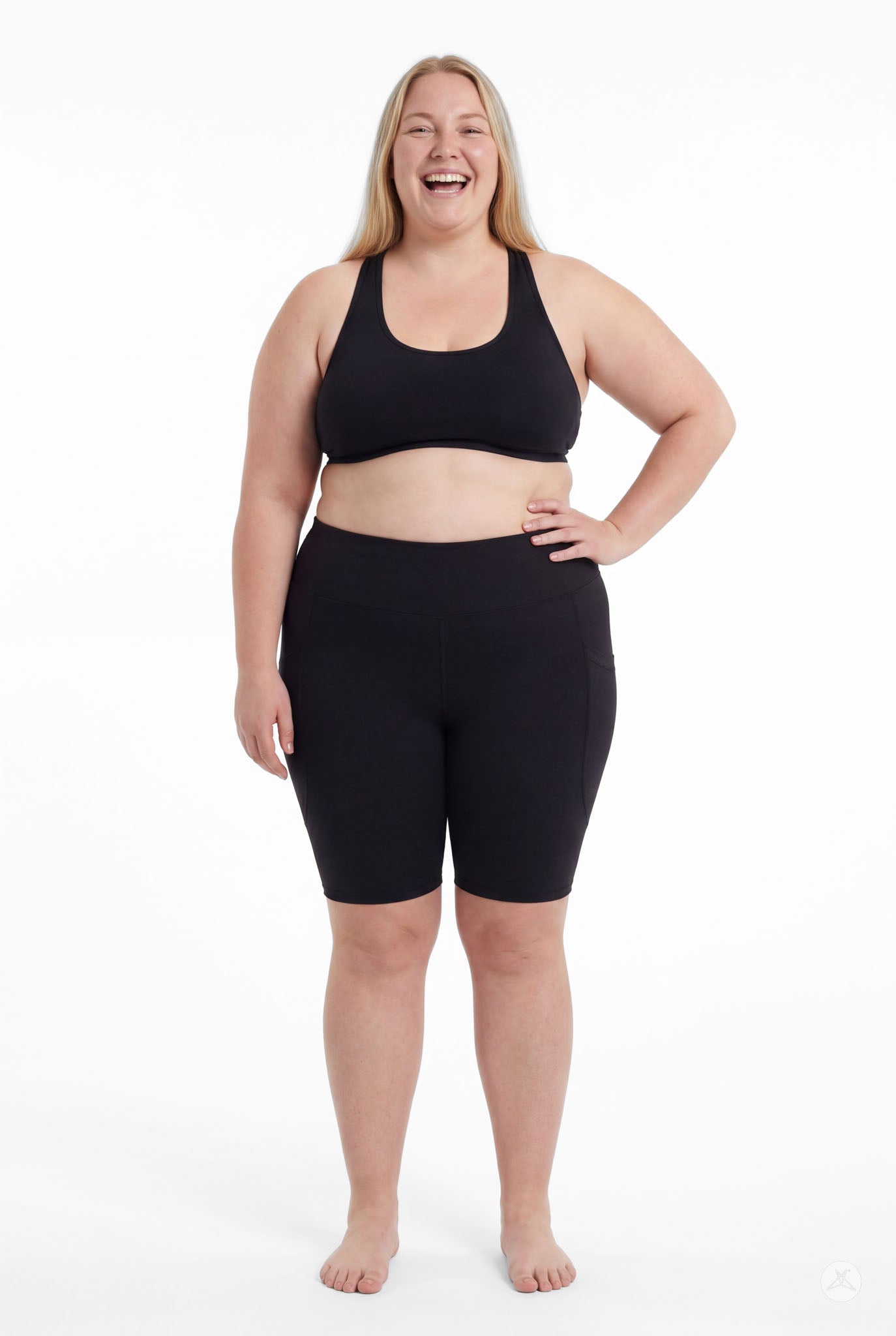 Plus size model confidently wearing SweetLegs Black High-Waisted Pocket Biker Shorts with hand on hip front view