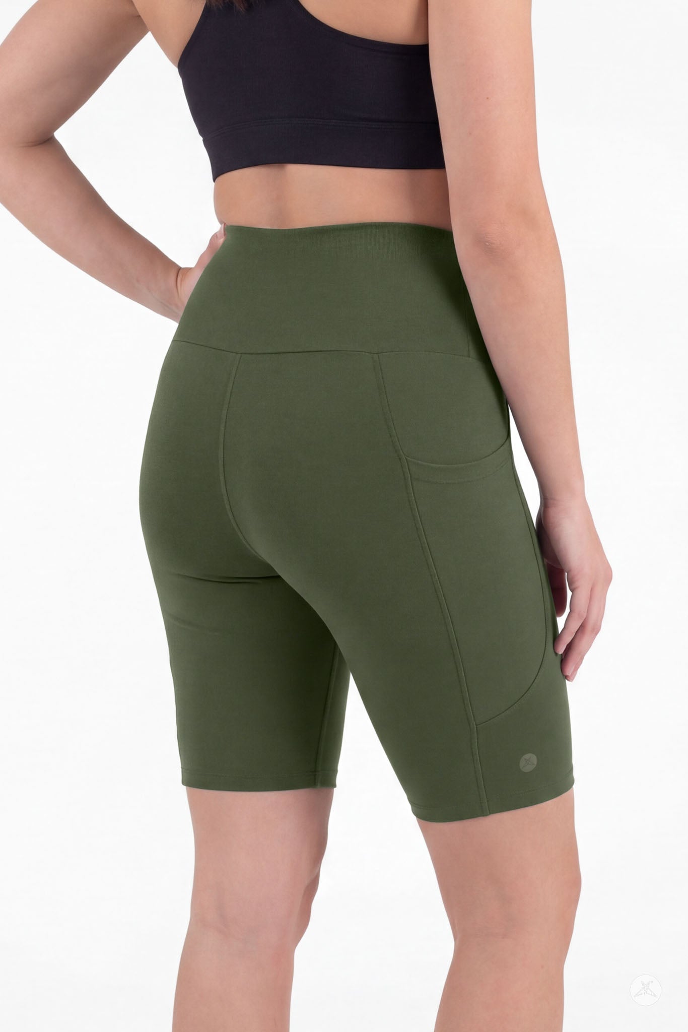 Woman wearing SweetLegs Cedar High-Waisted Pocket Biker Shorts in olive green with black crop top rear view