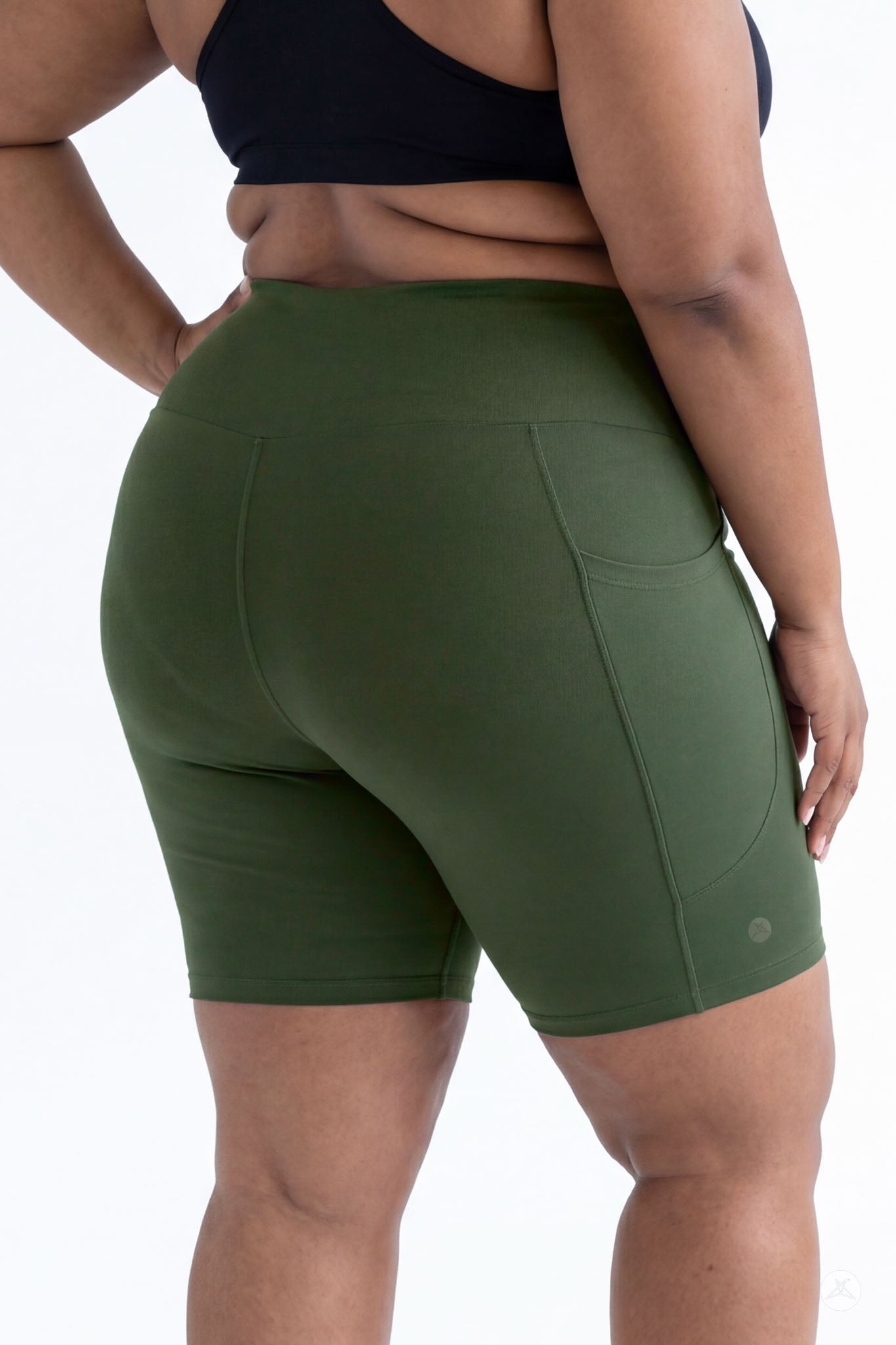 Plus size model wearing SweetLegs Cedar High-Waisted Pocket Biker Shorts in green showing back pocket and fit details