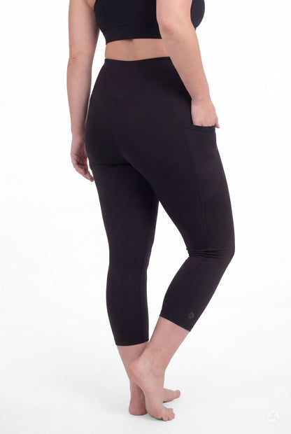 Curvy woman barefoot wearing SweetLegs Black High-Waisted Pocket Crops showing side pocket and back view