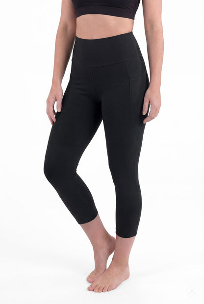 Woman barefoot wearing SweetLegs Black High-Waisted Pocket Crops with side pockets standing in relaxed front pose