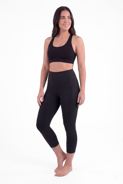 Woman barefoot wearing SweetLegs Black High-Waisted Pocket Crops with side pockets in relaxed standing pose