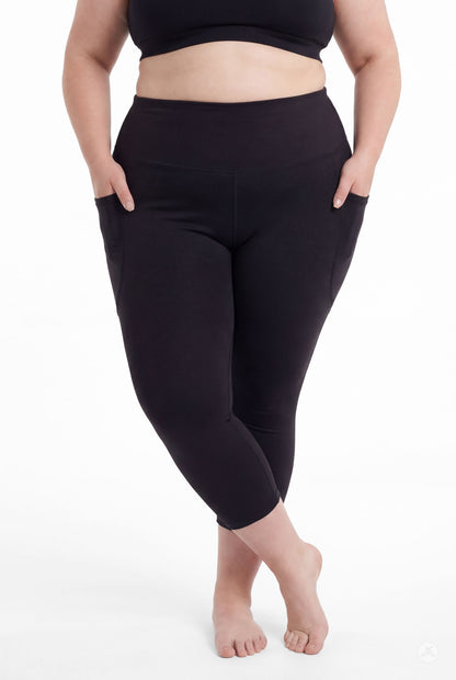 Plus size woman barefoot wearing SweetLegs Black High-Waisted Pocket Crops with hands in side pockets standing relaxed