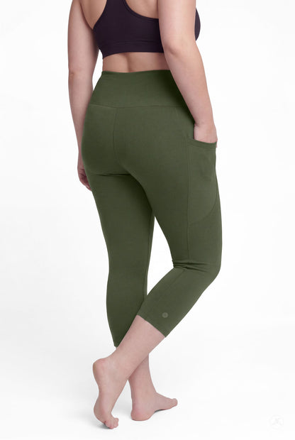 Woman barefoot showing back view wearing SweetLegs Cedar High-Waisted Pocket Crops in olive green with hand in pocket