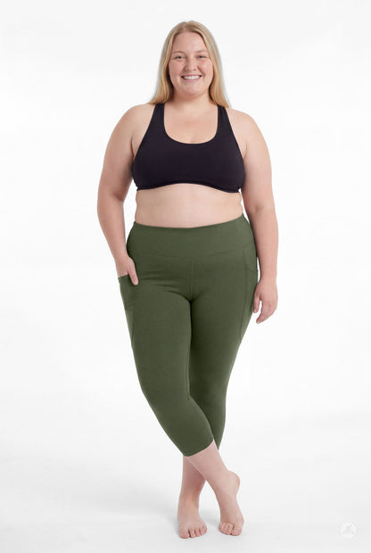Smiling plus size woman barefoot wearing SweetLegs Cedar High-Waisted Pocket Crops in green with hands in pockets