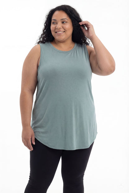 Plus size woman smiling wearing SweetTops High Neck Swing Tank in soft muted green with sleeveless relaxed fit from front angle